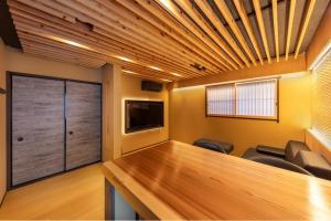 a conference room with a table and chairs and a television at KYORAN-FUKITEI - Vacation STAY 57002v in Kyoto