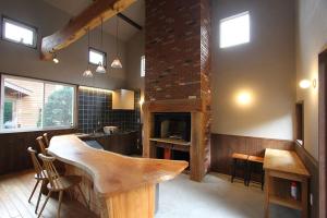 a kitchen with a bar and a fireplace at Kitakaruizawa Sweet Grass - Vacation STAY 61669v in Kita-karuizawa