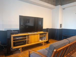a living room with a large flat screen tv at HARMONY HOTEL Urawa - Vacation STAY 18310 in Saitama