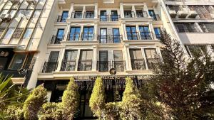 a tall white building with a lot of windows at Pell Palace Hotel & SPA in Istanbul