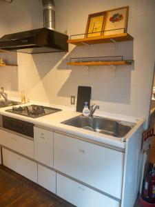 a kitchen with a sink and a stove at HARMONY HOTEL Urawa - Vacation STAY 18305 in Saitama