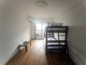 a small room with two bunk beds and a table at HARMONY HOTEL Urawa - Vacation STAY 18305 in Saitama