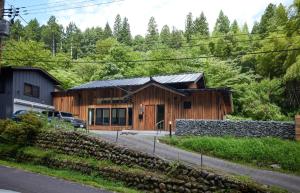 a wooden house with a car parked in front of it at Okuaga Totonoi-no-Yado VILLA IGASHIMA - Vacation STAY 87919v in Aga