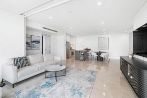 a living room with a couch and a table at Newest Views On The Beach in Gold Coast
