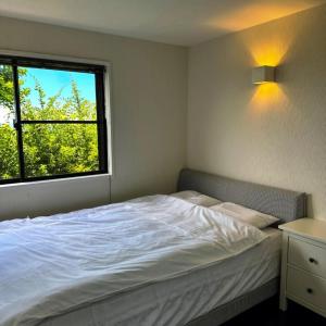 a bedroom with a white bed and a window at Sky Sauna Kukai - Vacation STAY 97168v in Kumamoto