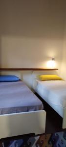 two beds sitting next to each other in a room at Villetta Cristina historic village Bellano-LC Comolake in Bellano