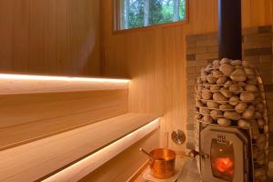 a wooden sauna with a wood stove in it at Guesthouse Nagomi in Minamiaso - Vacation STAY 17895 in Minami Aso