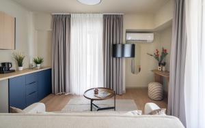 a living room with a bed and a table and chairs at Gnamma Hotel in Athens