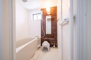 a bathroom with a tub and a toilet and a sink at BLUESOLARE Reef - Vacation STAY 14140v in Miyako Island +23 photos