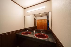 a bathroom with two red sinks and a large mirror at Suida no Yado - Vacation STAY 04892v in Yufuin +43 photos