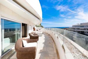 a balcony with chairs and a view of the ocean at Luxurious Penthouse in Marbella