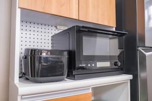a microwave and other appliances on a shelf in a kitchen at BLUESOLARE Aqua - Vacation STAY 14998v in Hirara