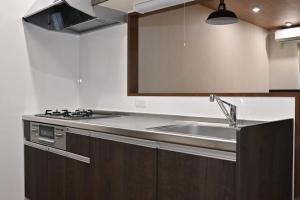 a kitchen with a sink and a mirror at BLUESOLARE Aqua - Vacation STAY 14998v in Hirara +25 photos