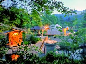 a cabin in the middle of a forest with a trash can at Hakuba Mori no Wasabi Farm Auto Campsite - Vacation STAY 22257v in Hakuba