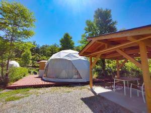 a tent with a picnic table and a table at Hakuba Mori no Wasabi Farm Auto Campsite - Vacation STAY 22254v in Hakuba