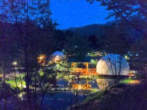 a night view of a white tent and a lake at Hakuba Mori no Wasabi Farm Auto Campsite - Vacation STAY 22254v in Hakuba +10 photos