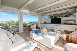 a living room with a white couch and a tv at Luxurious Penthouse in Marbella
