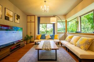 a living room with a couch and a tv at Gracia Shuzenji - Vacation STAY 28497v in Izu