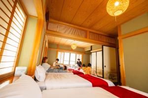 a group of people sitting on beds in a room at Gracia Shuzenji - Vacation STAY 28497v in Izu