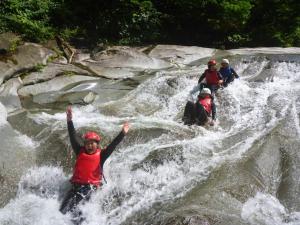 a group of people in the water on a waterfall at Minakami Outdoor Log & Auto Campsite - Vacation STAY 34002v in Obinata