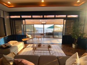 a living room with a couch and a table at Izu Base 73 - Vacation STAY 18722v in Okawa