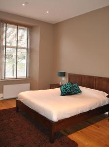 Un dormitorio con una cama con una almohada encima. en Dreamhouse Apartments Glasgow West End, en Glasgow