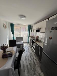 a kitchen and living room with a table and a refrigerator at Casa EDI in Ferihaza +15 photos