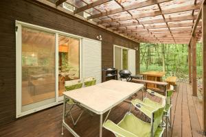 a patio with a table and chairs on a deck at Moriterasu Rin - Vacation STAY 38771v in Ōkuwa