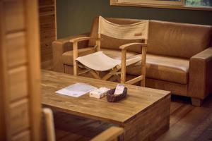 a living room with a couch and a chair and a coffee table at Moriterasu Rin - Vacation STAY 38771v in Ōkuwa +51 photos