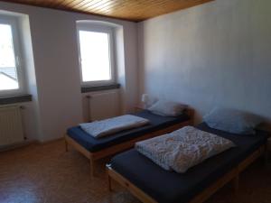 two beds in a room with two windows at Monteurhaus LK1 in Lissendorf +46 photos