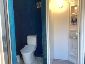 a small bathroom with a toilet and a blue wall at Halo KYOTO no UMI | Hello Kyoto no UMI - Vacation STAY 40860v in Yura