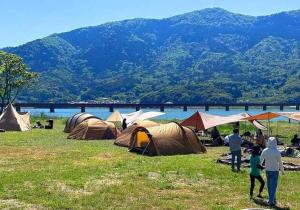a group of people standing around a field with tents at Halo KYOTO no UMI | Hello Kyoto no UMI - Vacation STAY 40860v in Yura