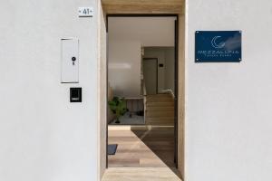 a door to a hallway with a sign on the wall at Mezzaluna Luxury Rooms by BarbarHouse in Mesagne