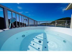 a hot tub on the balcony of a house at &SUN mini mini - Vacation STAY 17824 in Yokosuka