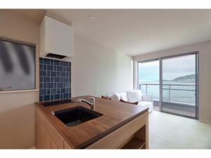a kitchen with a sink and a view of the ocean at &SUN mini mini - Vacation STAY 17824 in Yokosuka