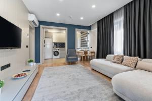 a living room with a couch and a table at Zeluxe Suite Hotel in Antalya