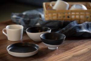 a group of bowls and cups on a wooden table at Town Stay 456 - Vacation STAY 26662v in Shizuoka