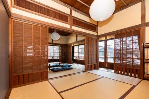 a japanese room with wooden walls and windows at R-house 5th - Vacation STAY 17834 in Numazu