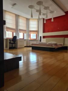 a bedroom with a bed and a red wall at Business Apart Arkadia in Odesa