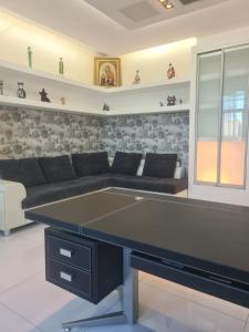 a ping pong table in a living room at Business Apart Arkadia in Odesa