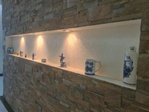 a stone wall with a shelf with vases on it at Business Apart Arkadia in Odesa