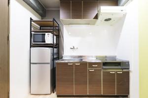 a kitchen with a refrigerator and a microwave at Utopia 21 - Vacation STAY 17955 in Sapporo