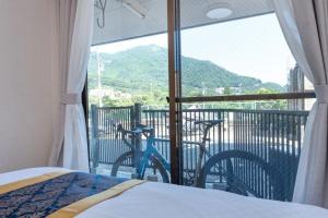 a bedroom with a bed and a bike on a balcony at J,Fine Miyagino 101 - Vacation STAY 27982v in Gora