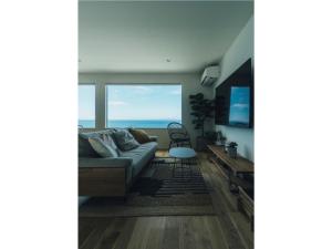 a living room with a couch and a view of the ocean at Viila NO°00 - Vacation STAY 34231v in Awaji
