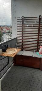 a bench on a balcony with a view of a city at Apartament Panorama miasta in Olsztyn