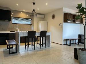 a kitchen with a table and chairs and a refrigerator at Onomichi Villa Ayah - Vacation STAY 53618v in Onomichi