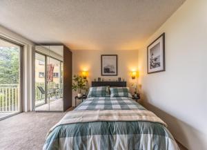 a bedroom with a bed and a balcony at Greenwich Property in Sydney
