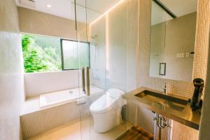 a bathroom with a toilet and a sink and a mirror at THEATER 1 - Vacation STAY 40858v in Motojuku