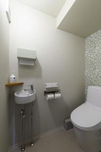 a bathroom with a toilet and a sink at guesthouse YAWNYAWN - Vacation STAY 40931v in Echizen