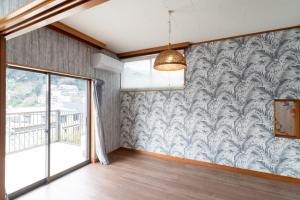 a living room with a wall mural of palm trees at Long - Vacation STAY 56447v in Manazuru